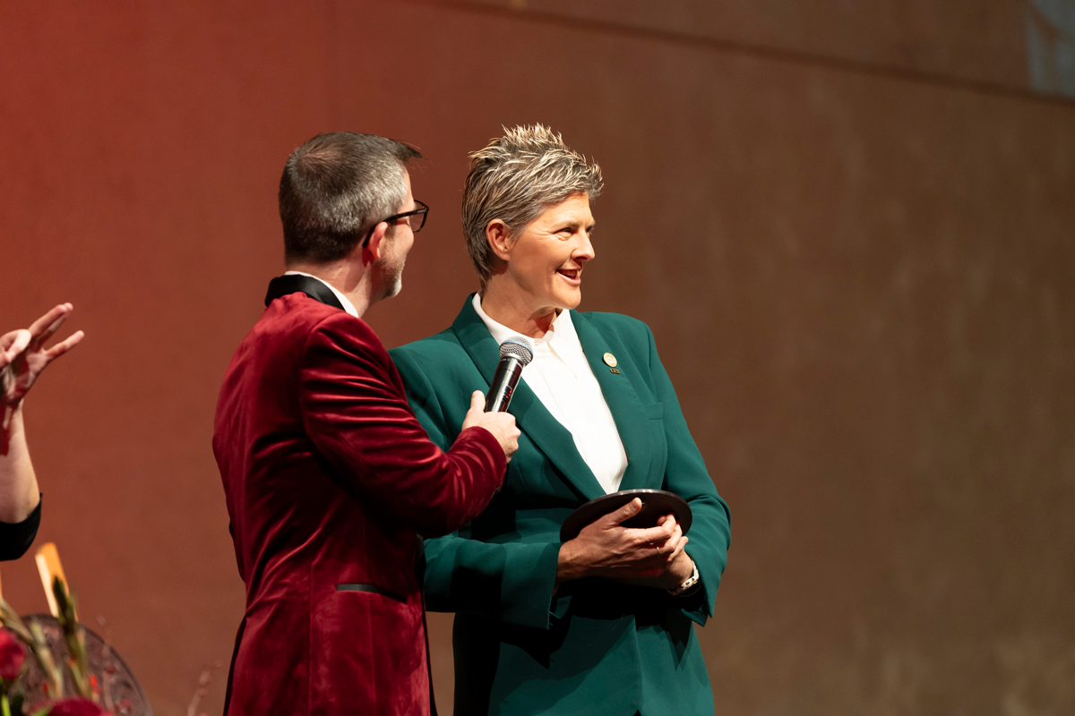 Natalie Cook OAM OLY speaking on stage as she accepts her 2024 Queensland Greats Award