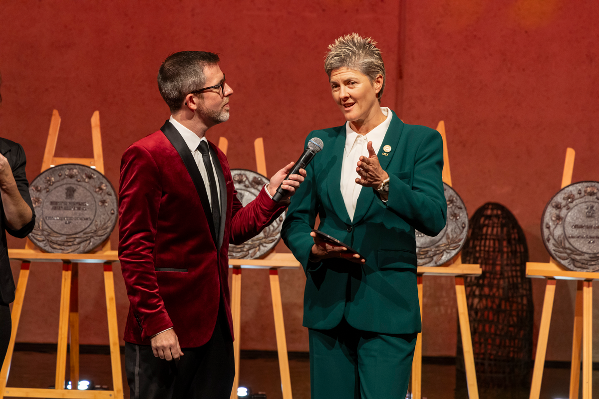 Natalie Cook OAM OLY speaking on stage as she accepts her 2024 Queensland Greats Award