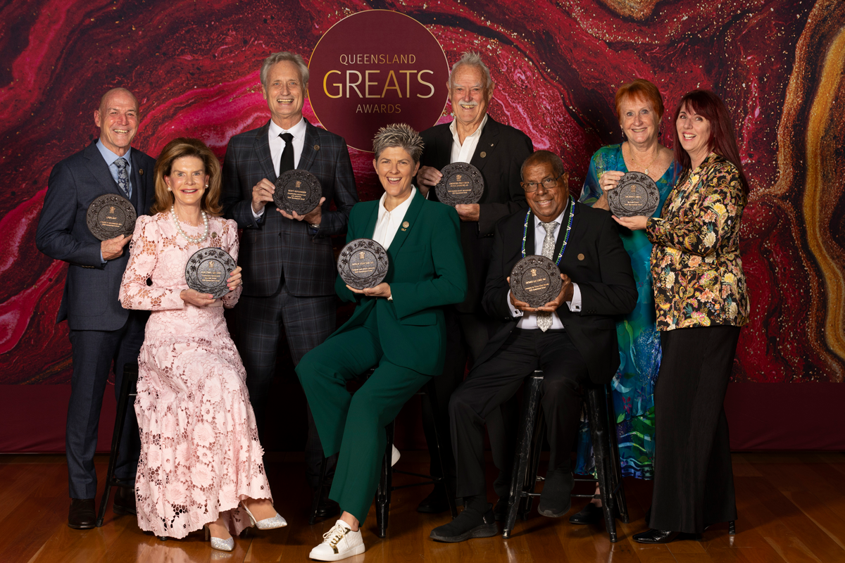 Queensland Greats Awards 2024 recipients including Natalie Cook OAM OLY, seated and holding their plaques