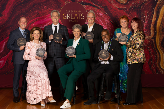 Queensland Greats Awards 2024 recipients including Natalie Cook OAM OLY, seated and holding their plaques